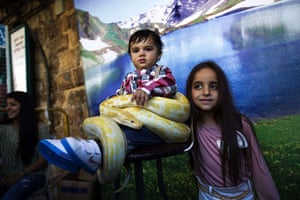 24 hours: Acre, Israel: Children pose with a snake