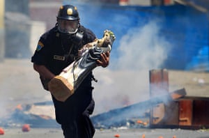 24 hours: Lima, Peru: A policeman removes a statue of Saint Rose