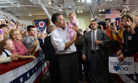 US Republican presidential candidate Mitt Romney holds a supporter's baby during a campaign rally at Avon Lake High School in Avon Lake, on Ohio.