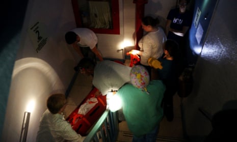 Hospital workers evacuate patient Deborah Dadlani from NYU Langone Medical Center during Hurricane Sandy.