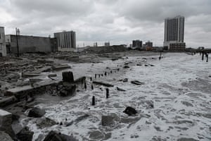 Coastal aftermath: Waves crash over the remains of a boardwalk in Atlantic City, New Jersey