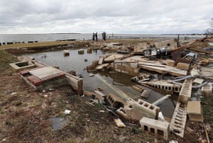 Coastal aftermath update: Visitors check out the foundations of a home in Amity Harbor, New York
