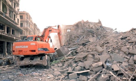 A digger working at the site of three explosions that rattled Saadallah al-Jabiri Square in Aleppo on Wednesday.