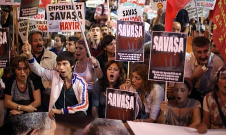 Demonstrators hold placards reading "No War" and shout slogans as they take part in a protest against a possible war with Syria, in Istanbul.
