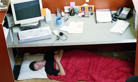 man sleeps under office desk