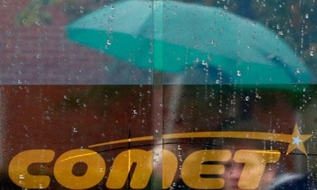 Shoppers are reflected in the window of a Comet store in Burton upon Trent