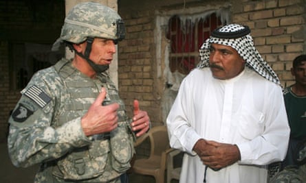 The then US commander in Iraq, General David Petraeus, left, talks with Assal Jassim