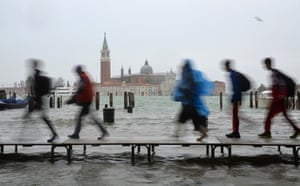 Venice floods: Tourists walk on wooden walkways