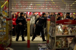 Euro protests: Madrid, Spain: Demonstrators shout slogans in front of a shop