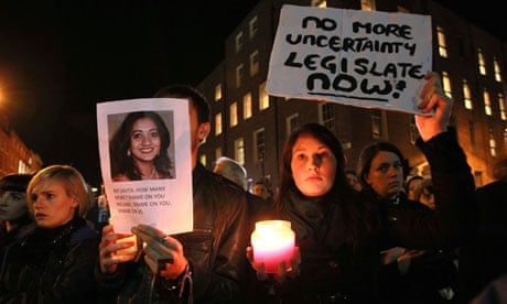 Irish protesters hold pictures of Savita Halappanavar who died after being refused an abortion