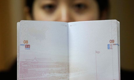 A woman holds a Chinese passport in Wuhan