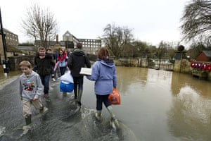 UK flooding: People wade through floodwaters in Malmesbury