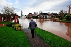 UK flooding: An elderly woman comes to the end of the footpath in Somerset