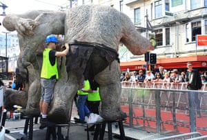 The Hobbit premiere: A workman makes last minute adjustments to a troll's loin cloth