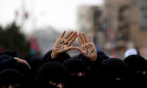 A female protester displays her hands painted with Arabic reading, 'no dialogue before the sons leave', during a demonstration outside the residence of Yemen's president Abed Rabbu Mansour Hadi demanding the removal of former President Saleh's relatives in Sanaa, Yemen.