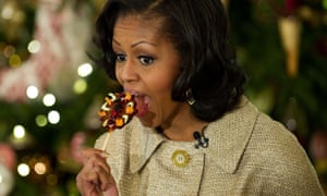 Michelle Obama takes a bite out of a lollipop during the first viewing of the White House 2012 holiday decorations.