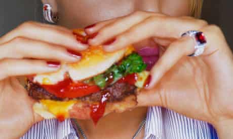 Woman Eating Cheeseburger