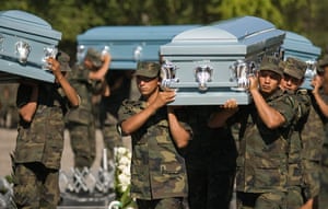 Mexico Drug Wars: December 2008: Soldiers carry coffins during the funeral of six men