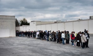 People wait in line for early voting in the parking lot of the Northland Park Center on 4 November 2012 in Columbus, Ohio.