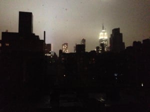 Dark Manhattan skyline, some lights