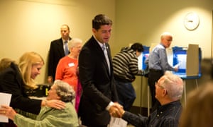 Paul Ryan greets a poll worker as he votes with his family in Janesville, Wisconsin.