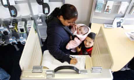 A Chicago voter casts her vote with her two children