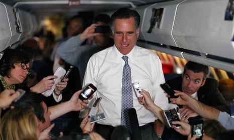 Mitt Romney talks with members of the traveling press aboard his campaign plabe on 6 November, 2012 en route to Boston, Massachusetts.