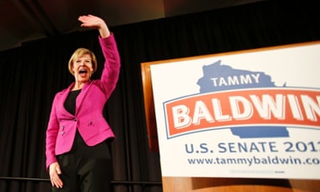 The US's first openly gay senator, Tammy Baldwin, waves to supporters after making her a victory speech in Madison, Wisconsin. 