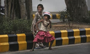 A young Indian girl dances as she wears a hat celebrating outside the US embassy in New Delhi, India.