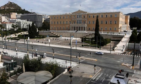 A police car drives through one of Athens' usually busiest avenues in front of the parliament in Syntagma square November 7, 2012 during a 48-hour strike by the two major Greek workers unions.