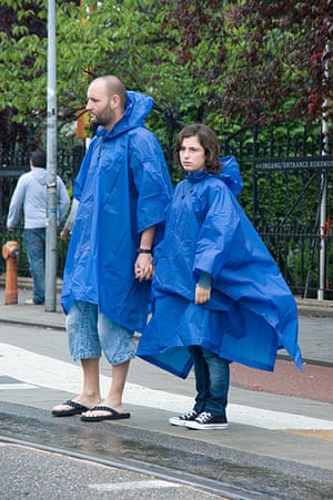 Big Picture: Couples: A couple dressed in matching blue waterproof ponchos