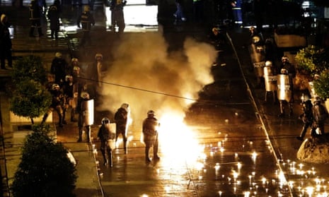 A petrol bomb thrown by protesters explodes near riot police in front of parliament during clashes in Athens, Wednesday Nov. 7, 2012. 