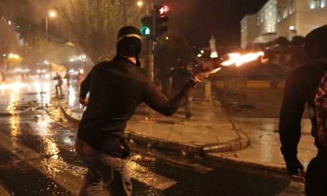 A protestor throws a molotov cocktail at riot police during a 48-hour strike by the two major Greek workers unions in central Athens November 7, 2012.