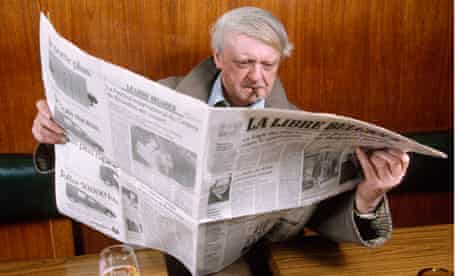 Anthony Burgess reading Belgian newspaper La Libre Belgique while smoking