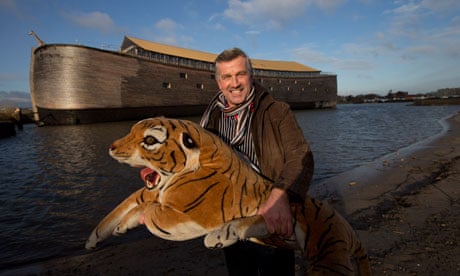 Johan Huibers poses with a stuffed tiger in front of his Noah's ark