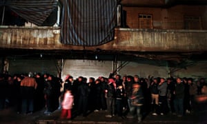 Syrians gather outside a bakery in the Shaar neighbourhood of Aleppo.