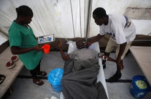 2012 in MDG: Staff assist a cholera patient in Sierra Leone's capital Freetown