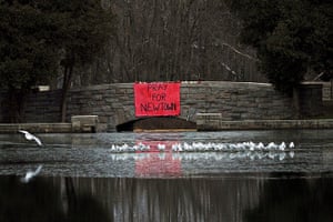 Sandy Hook: A sign reading Pray for Newtown hangs from a stone bridge over Hawley Pond
