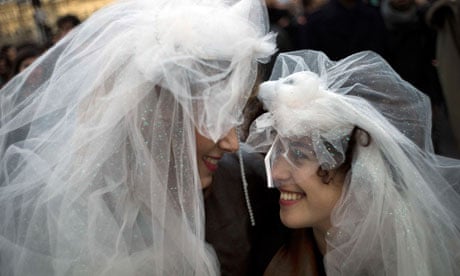 Two women wearing wedding veils