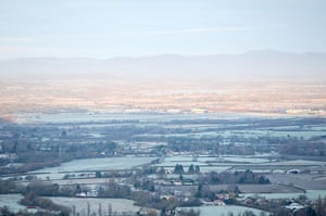 cold  uk weekend weather: The Malvern Hills are seen at dawn across frozen Gloucestershire farmland 