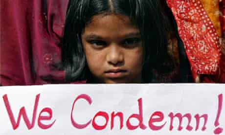 Girl holds a placard as she takes part in a protest rally in Hyderabad