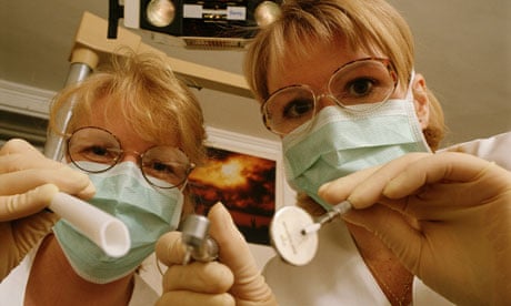 Dentist and nurse examine patient