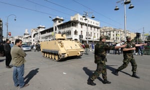 Egyptian Army deploy near the presidential palace to secure the site after overnight clashes between supporters and opponents of President Mohammed Morsi.