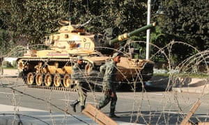 Soldiers carry barbed wire to be installed around the presidential palace area after tanks were deployed to stop clashes between supporters and opponents of Egyptian president Mohamed Morsi.