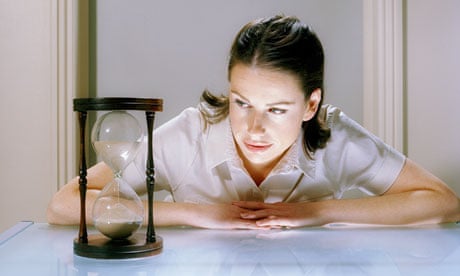 woman looking at hourglass