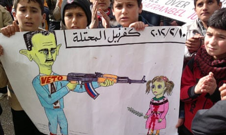 Demonstrators hold a poster during a protest against Syria's President al-Assad 