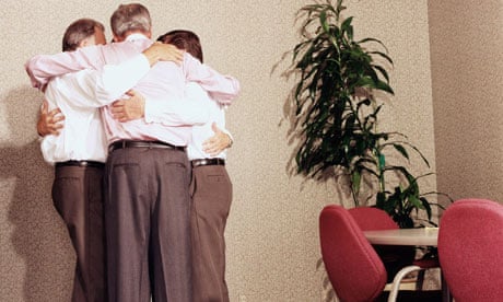 A group of businessmen hugging