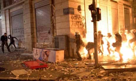 Greek demonstrators throw fire bombs at riot police during violent protests in central Athens