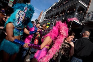 Mardi Gras: A couple in horse masks dance on Bourbon Street