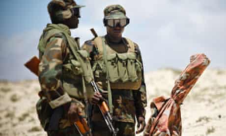 Ugandan gunners with an 80mm mortar watch al-Shabaab positions in Mogadishu, Somalia